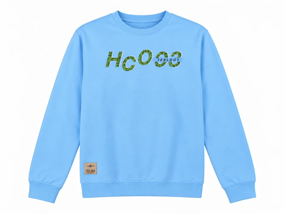 Sky blue long-sleeved crewneck sweatshirt with green chest graphic and beige lower woven patch