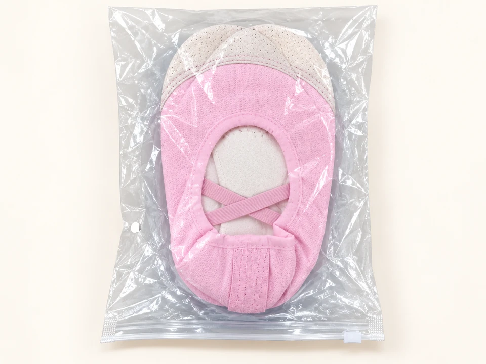 Pink Ballet Flats on a warm studio background