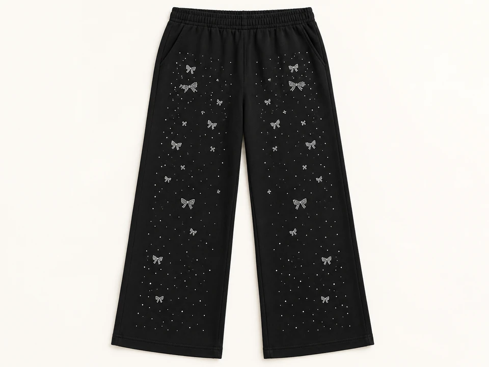Black Rhinestone Bow Wide-leg Trousers on a warm studio background